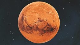 Imagem do planeta Marte, em fundo escuro.