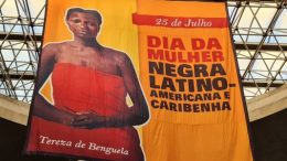 imagem de uma grande bandeira amarela com a imagem de Terea de benguela e a incrição 25 de julho, dia da mulher negra latino americana e caribenha