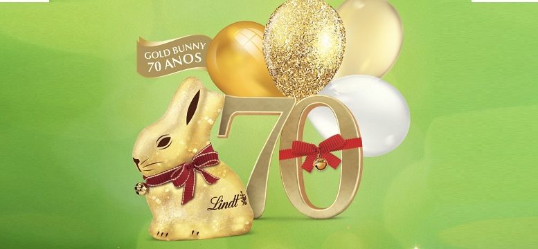 imagem do coelho de chocolate da Lindt, com bolas de ar douradas e o número 70 com um laço vermelho, além de uma inscrição gold bunny 70 anos