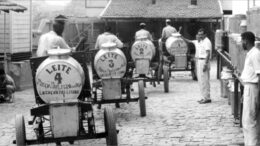 foto antiga de carrocinhas de leite (galões em estrutura com rodas)