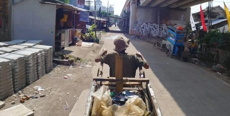 imagem de catador de reciclaveis com carrinho andando em viela aberta em baixo de viaduto
